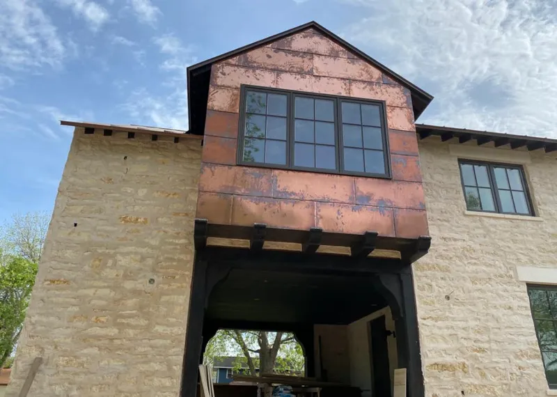 Copper metal panel facade on a stone building for Metal Roof Coating in Champion Heights